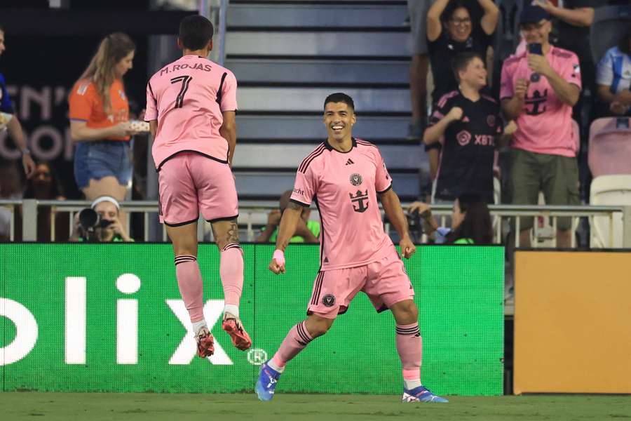 Luis Suarez (r) celebrates another goal