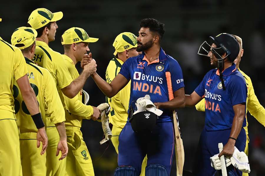 Yadav (blue L) congratulates the Australia players on their win