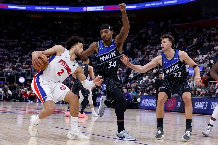 Detroit Pistons guard Cade Cunningham is defended by Orlando Magic centre Wendell Carter Jr. and forward Franz Wagner