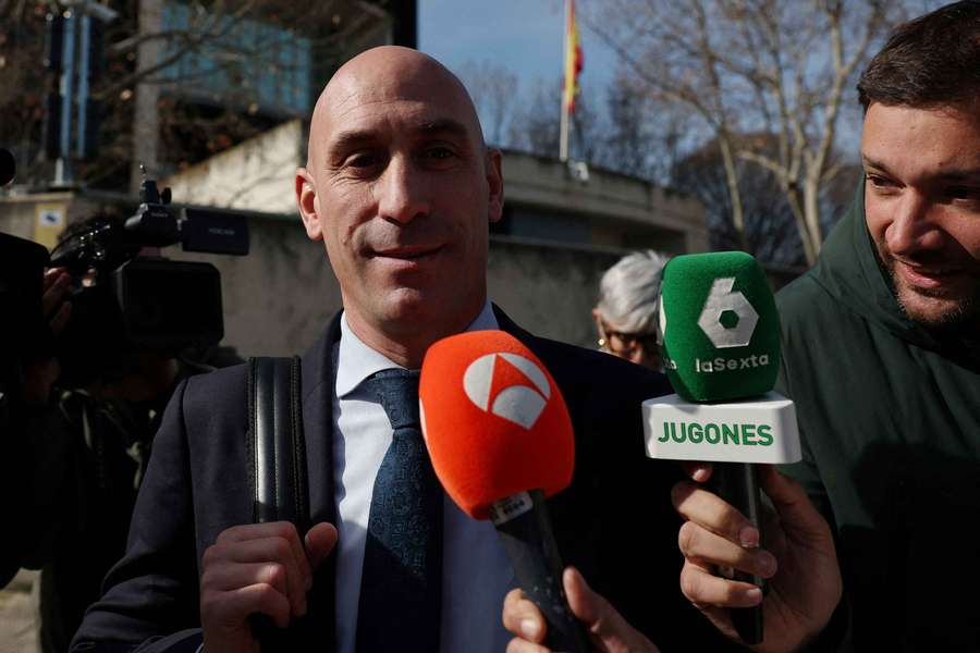Luis Rubiales with members of the media as he leaves the court