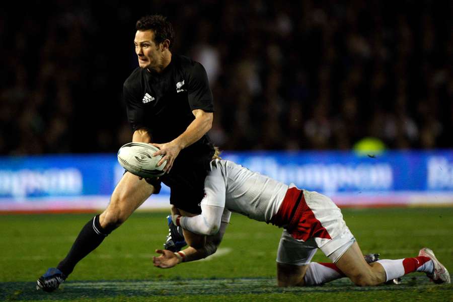  All Blacks' Leon MacDonald is caught by England's defence during their international rugby test match in 2008