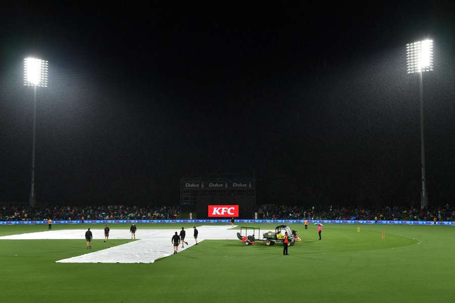 A general view shows the covers on the pitch as rain delays the first Twenty20