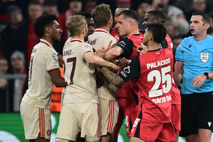 Harry Kane and Granit Xhaka get involved in a scuffle during their round of 16 Champions League showdown on Wednesday