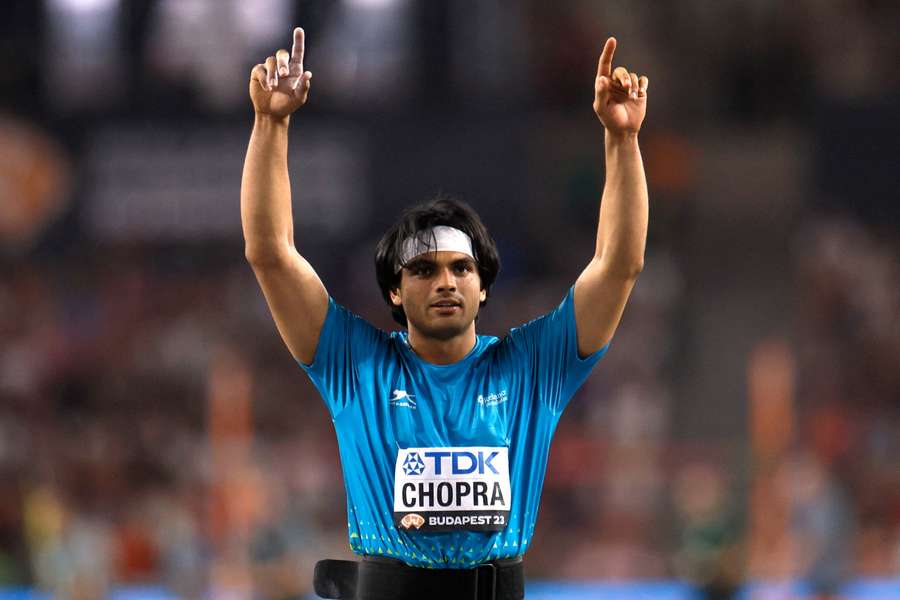 Neeraj Chopra raises his arms after winning the javelin final