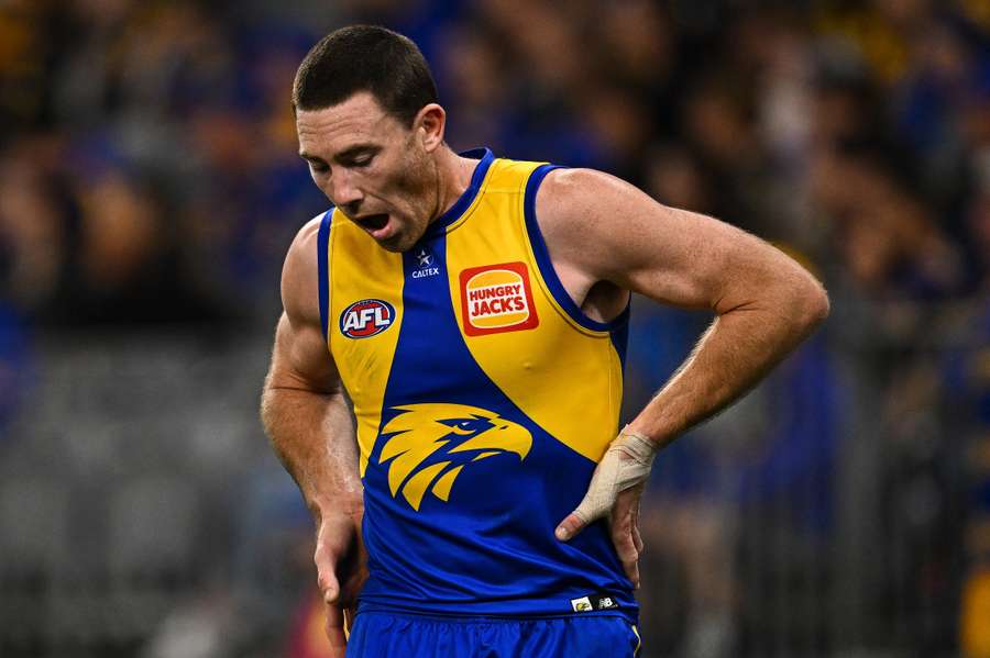 Jeremy McGovern winces after copping a knock during his final AFL game.