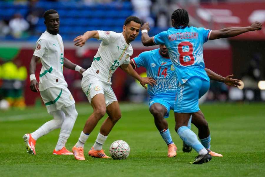 Iliman Cheikh Baroy Ndiaye is challenged by DR Congo's Samuel Moutoussamy and Noah Sadiki 