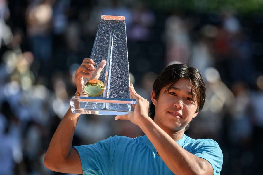Learner Tien celebrates with the winner's trophy Learner Tien celebrates with the winner's trophy