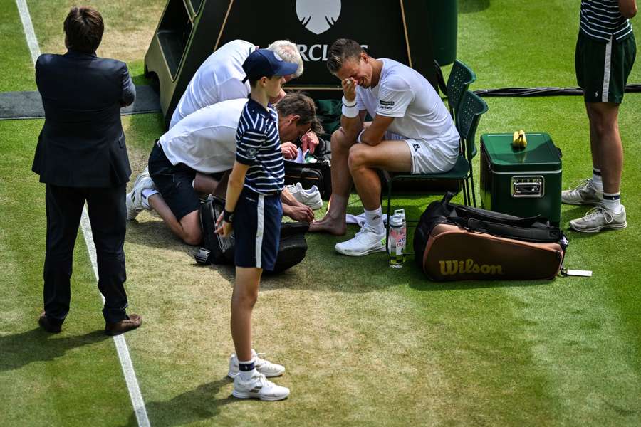 Jiri Vesely reacts as he receives medical attention for his foot