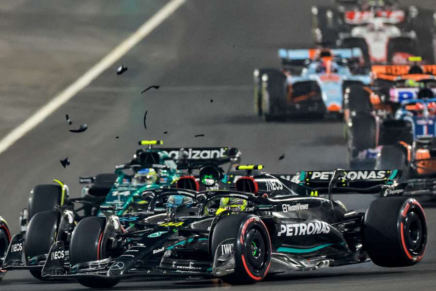 Mercedes' British driver George Russell (C) and Mercedes' British driver Lewis Hamilton (R) collide