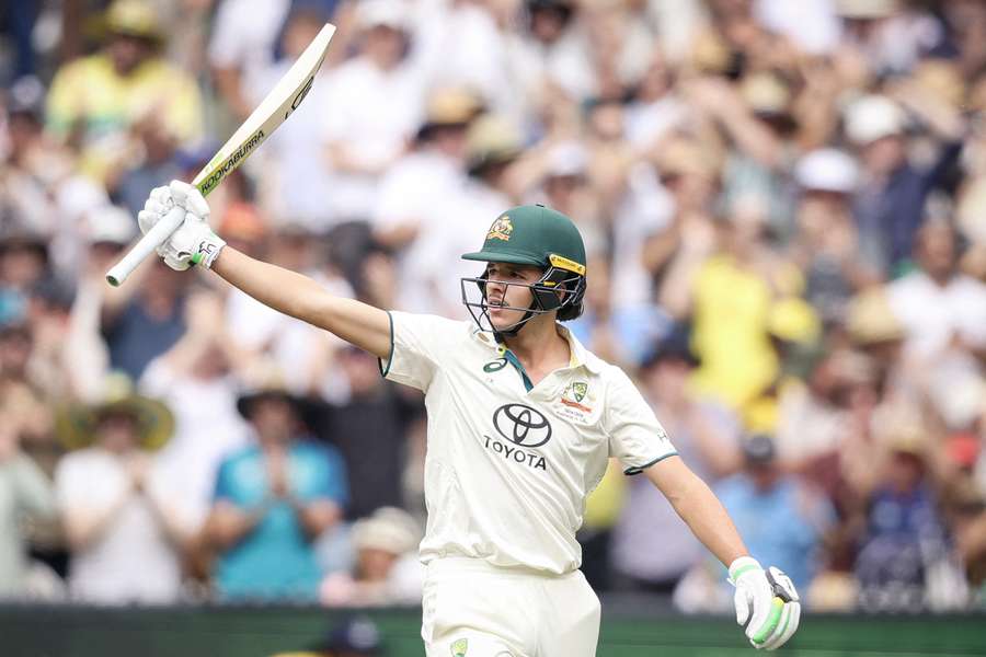 Sam Konstas raises his bat after passing 50 runs on day one of the fourth Test between Australia and India at the MCG