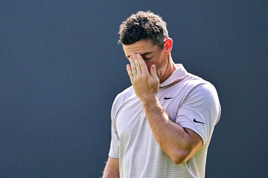 Rory McIlroy reacts after putting on the ninth hole during the first day of the Dubai Desert Classic