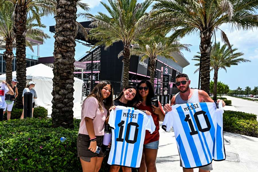 Fans of Argentine football player Lionel Messi pose for a photo while waiting for his arrival at the DRV PNK Stadium in Fort Lauderdale, Florida