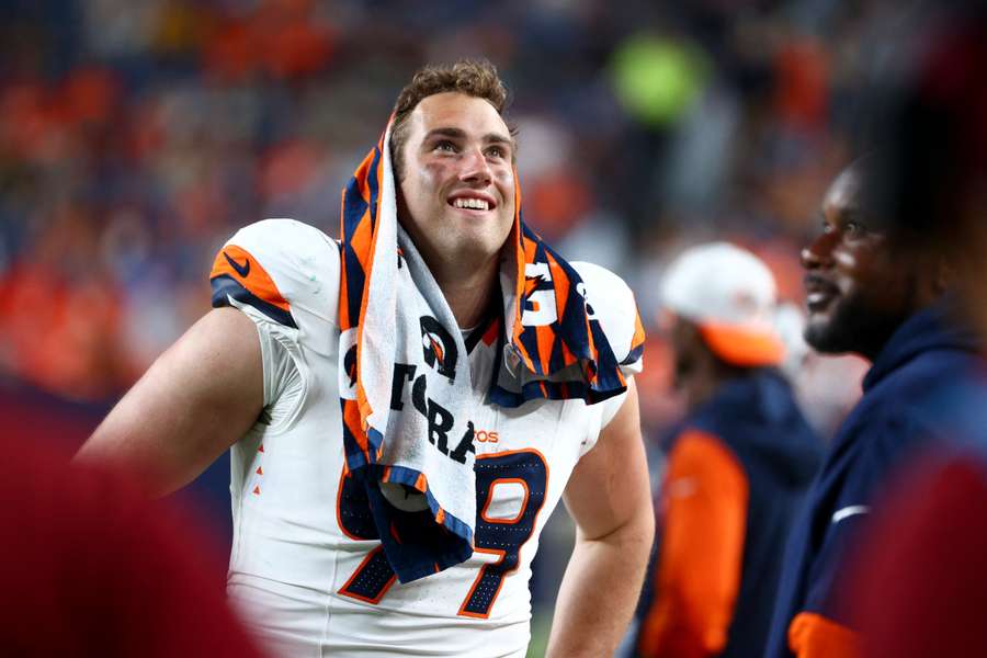 Zach Allen smiles on the sidelines during a game (2024)