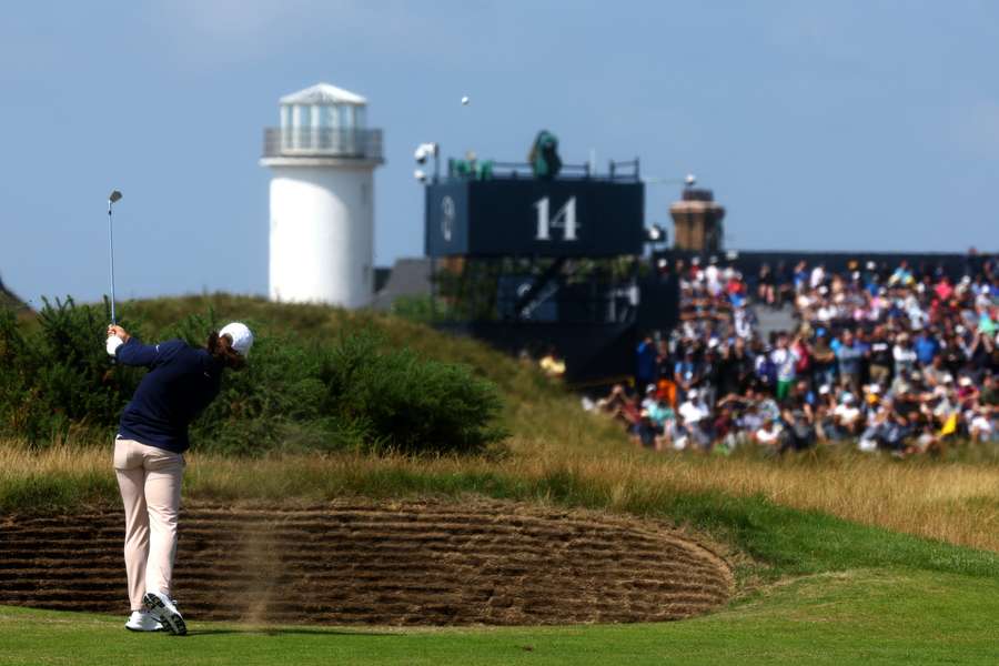 Tommy Fleetwood plays his approach shot into the 14th hole