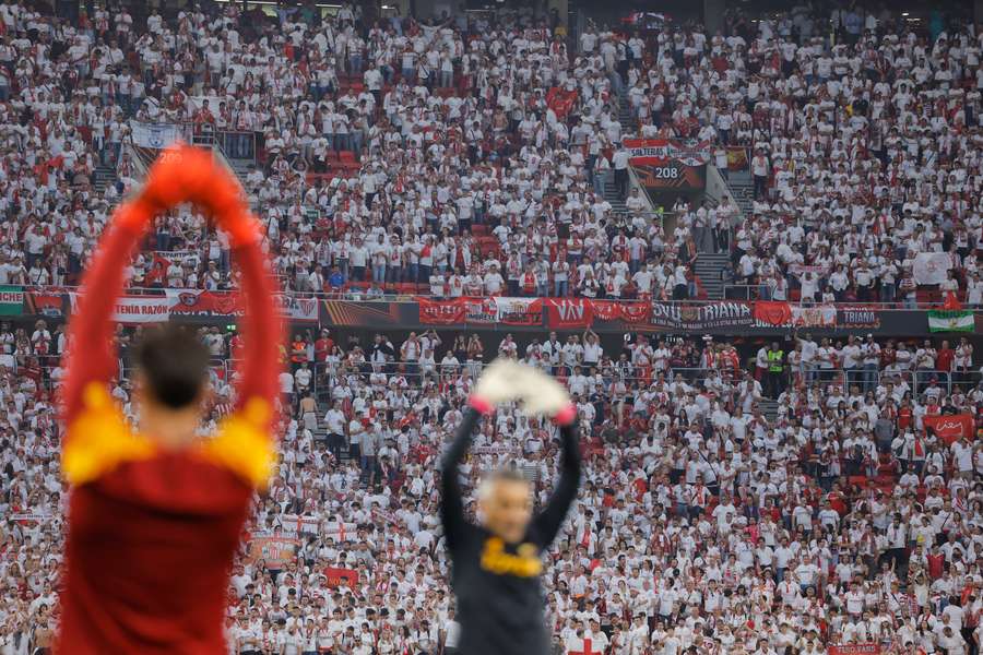 Sevilla supporters watch as players warm up