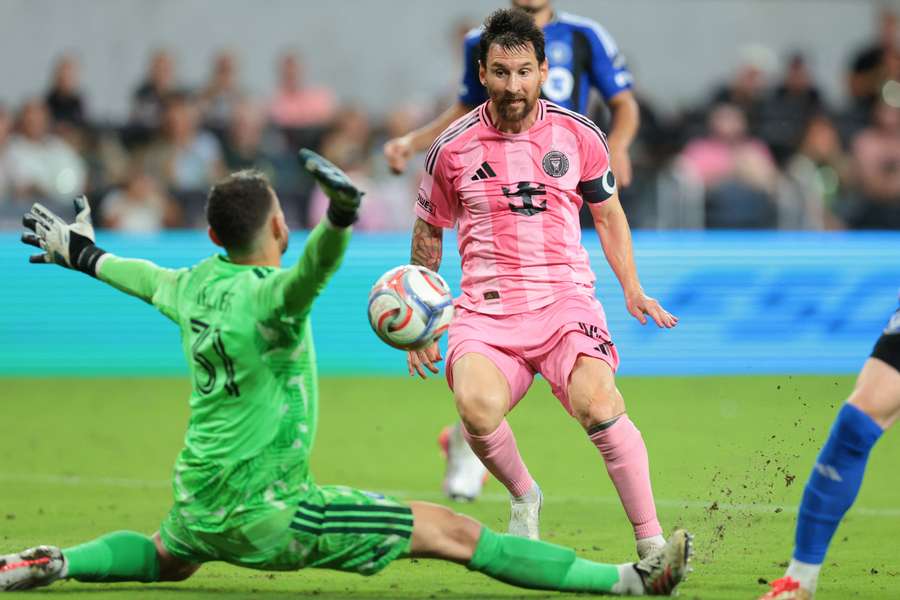Lionel Messi scores against CF Montreal goalkeeper Thomas Gillier during the second half at NU Stadium