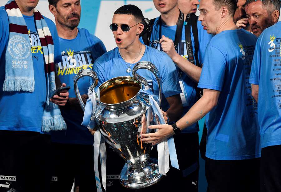 Phil Foden celebrates with the Champions League trophy