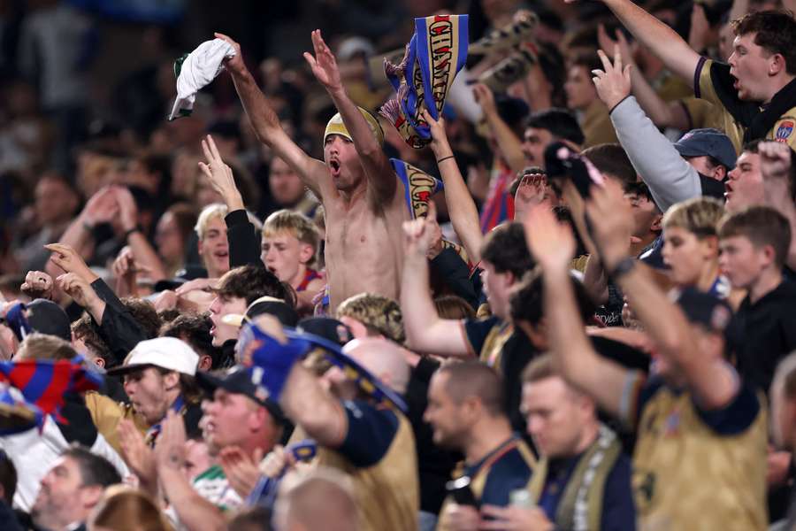 Newcastle Jets fans celebrate their goal against Sydney FC at the weekend. Newcastle Jets fans celebrate their goal against Sydney FC at the weekend.