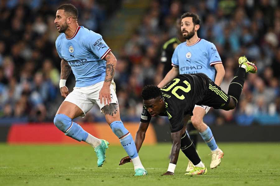 Vinicius Junior falls to the pitch after a challenge from Kyle Walker Vinicius Junior falls to the pitch after a challenge from Kyle Walker