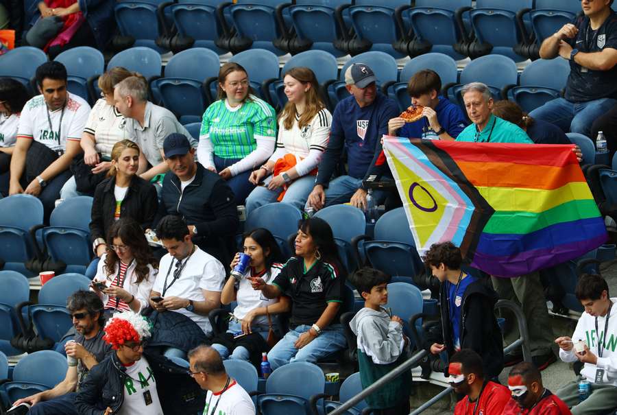 A fan brings a pride flag into Seattle Stadium.