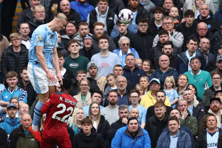 Manchester City's Norwegian striker #09 Erling Haaland (L) heads home their second goal