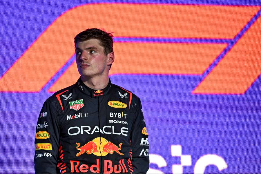 Verstappen reacts on the podium