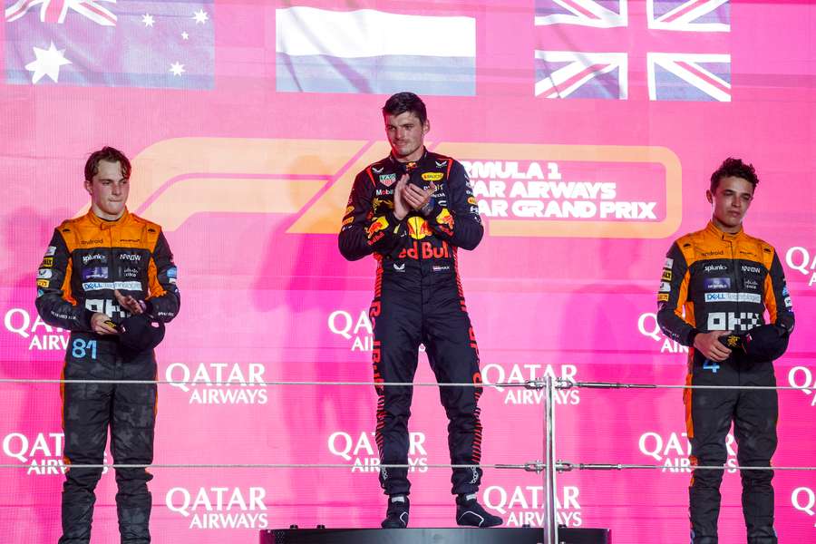 McLaren's Australian driver Oscar Piastri, (L) Red Bull Racing's Dutch driver Max Verstappen, (C) and McLaren's British driver Lando Norris celebrate on the podium