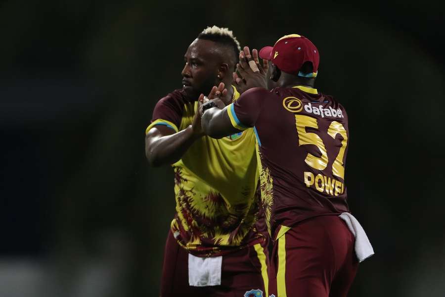 Powell celebrates with Andre Russell