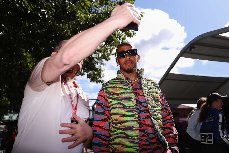 A fan takes a selfie with Mercedes' British driver Lewis Hamilton