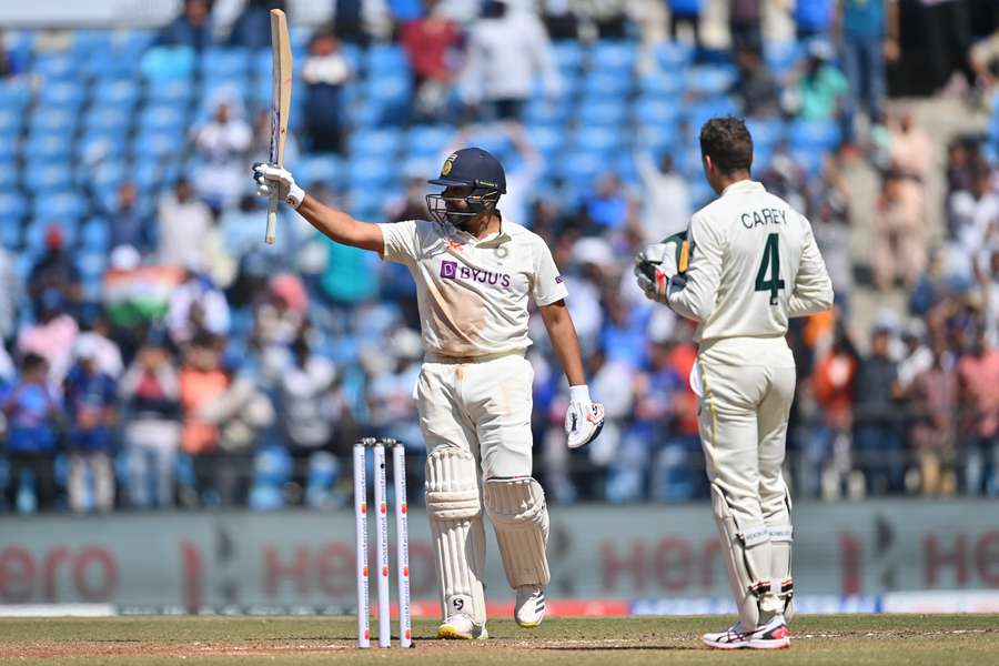 India's captain Rohit Sharma (L) celebrates after scoring a century 