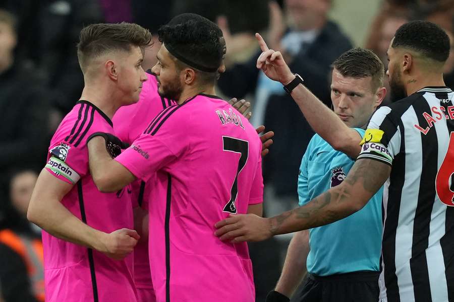 Fulham's Mexican striker #07 Raul Jimenez (2L) reacts having been sent off