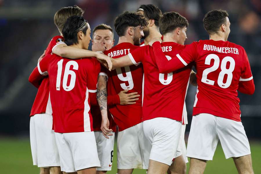 AZ Alkmaar players celebrate their team's goal against Tottenham