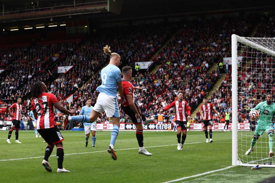 Manchester City's Norwegian striker Erling Haaland scores the opening goal