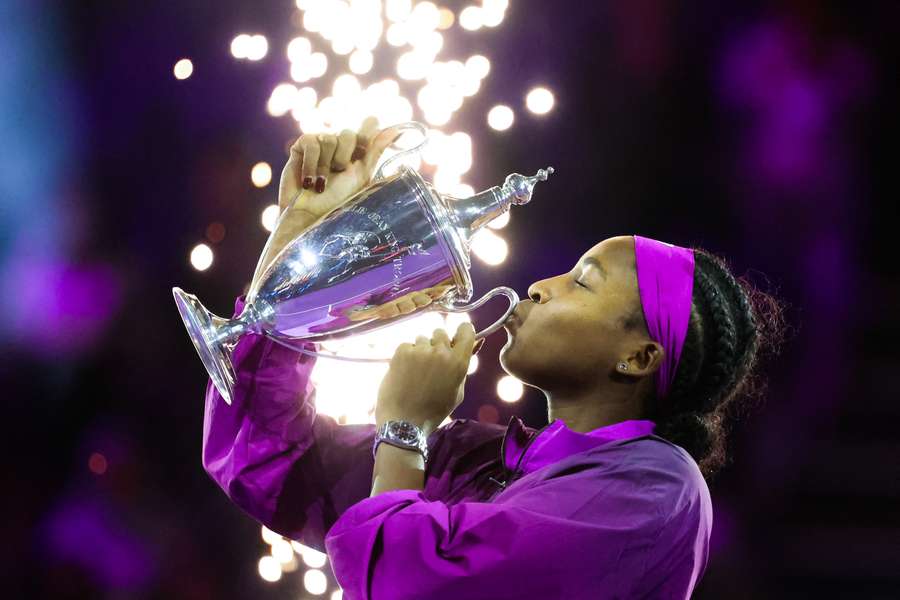 Coco Gauff celebrates with the trophy after defeating Zheng Qinwen at the WTA Finals Championship in Riyadh