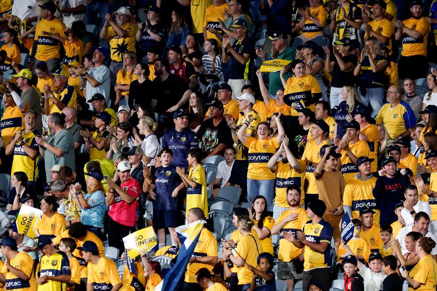Central Coast Mariners fans celebrate a goal at home to Brisbane Roar earlier this season.