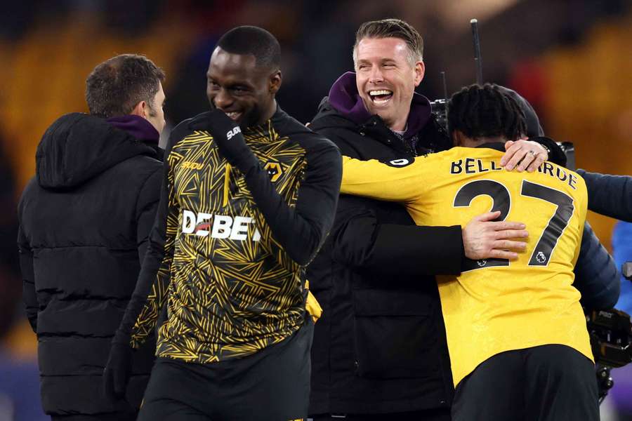 Wolves manager Rob Edwards and Jean-Ricner Bellegarde celebrate