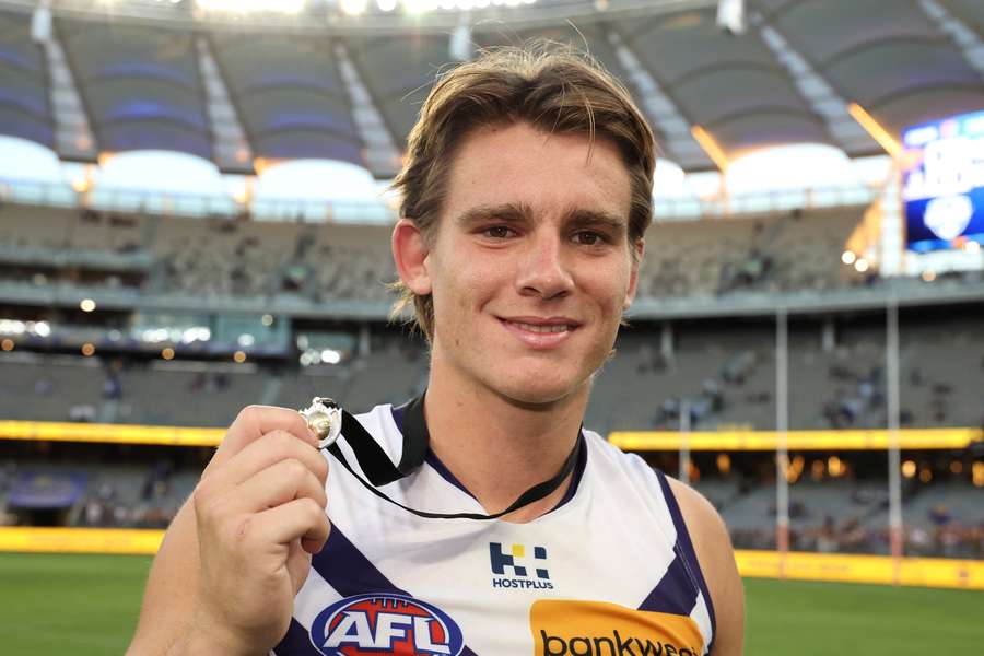 Fremantles' Caleb Serong poses with the Glendinning-Allan Medal, awarded to the best man on the field for each Western derby.