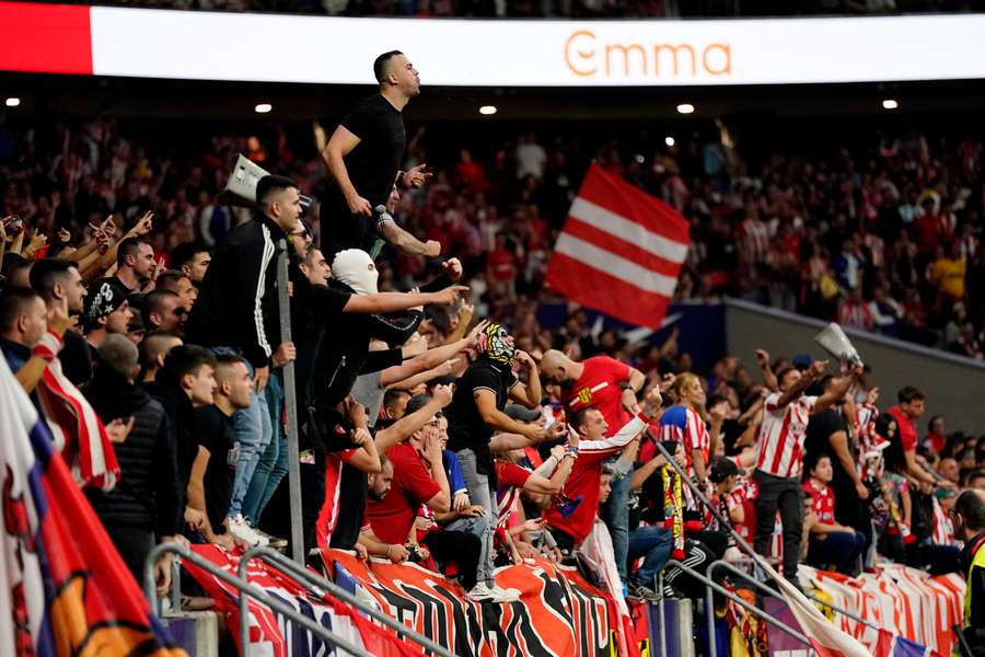 Atletico Madrid fans in the stands as play is stopped due to crowd trouble against Real Madrid