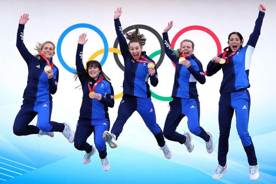 Team GB's Mili Smith (L) and Eve Muirhead (R) celebrate with teammates after winning curling gold at Beijing 2022