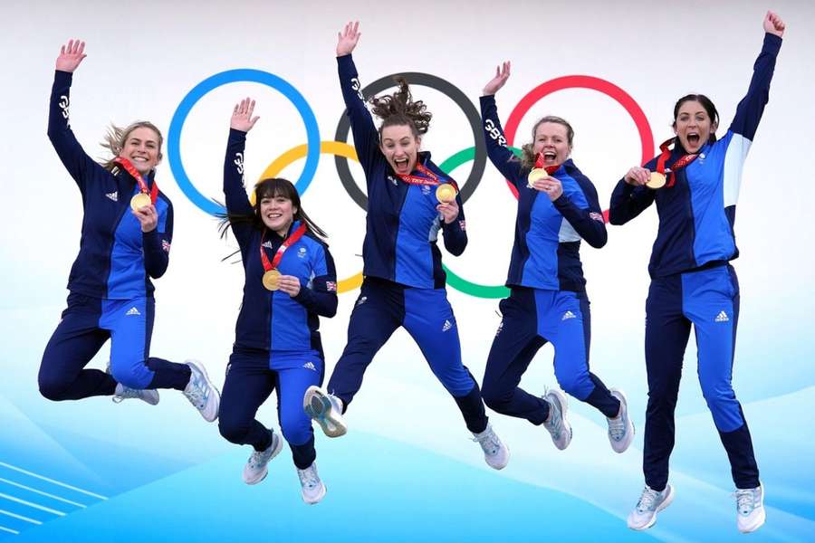 Team GB's Mili Smith (L) and Eve Muirhead (R) celebrate with teammates after winning curling gold at Beijing 2022