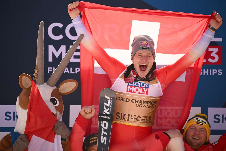 Switzerland's Marco Odermatt celebrates winning his first downhill gold
