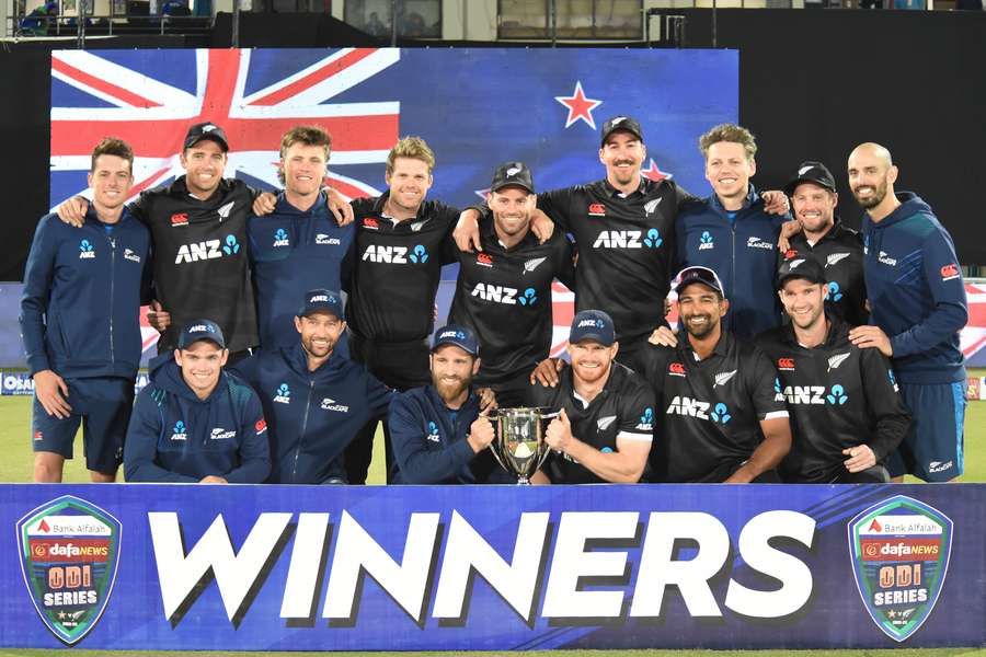 New Zealand’s players pose with the winners' trophy on the third and final one-day international (ODI) cricket match between Pakistan and New Zealand