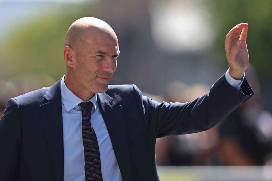 Zinedine Zidane waves to fans after he is unveiled as the new head coach of France