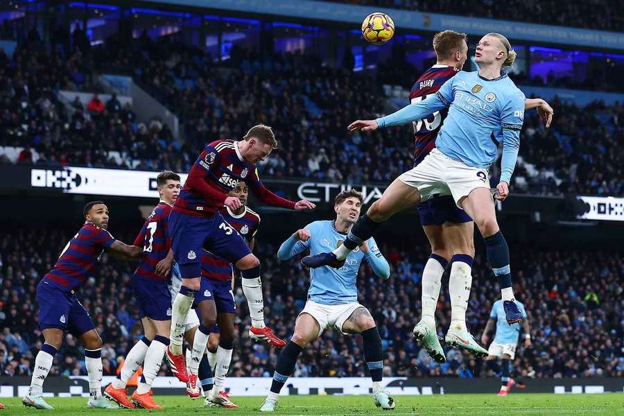 Man City's Erling Haaland jumps for the ball against Newcastle United