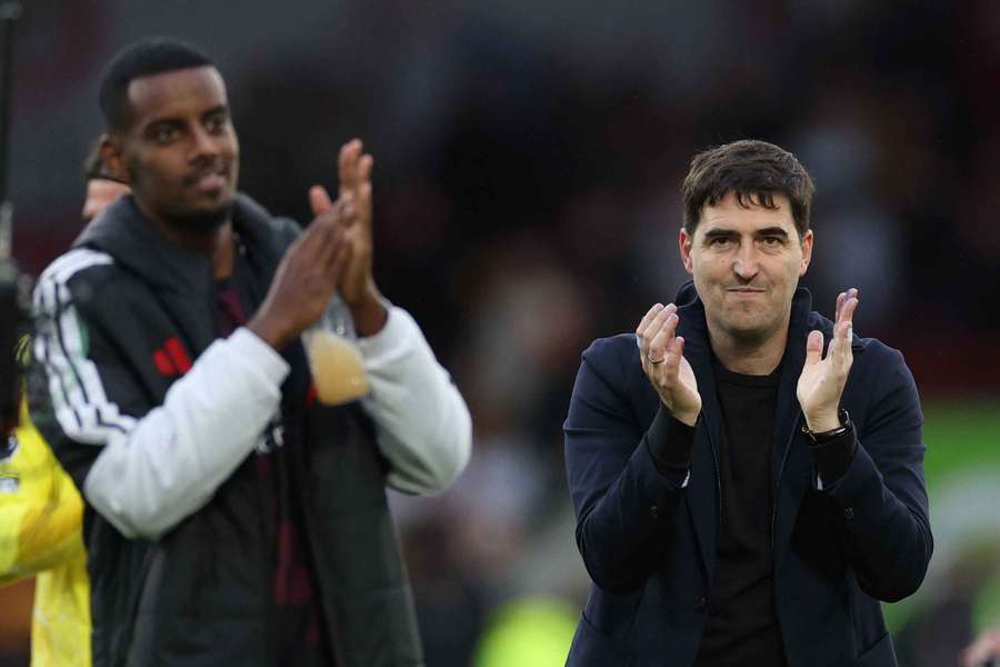 Liverpool manager Andoni Iraola and Liverpool's Alexander Isak applaud fans after the match