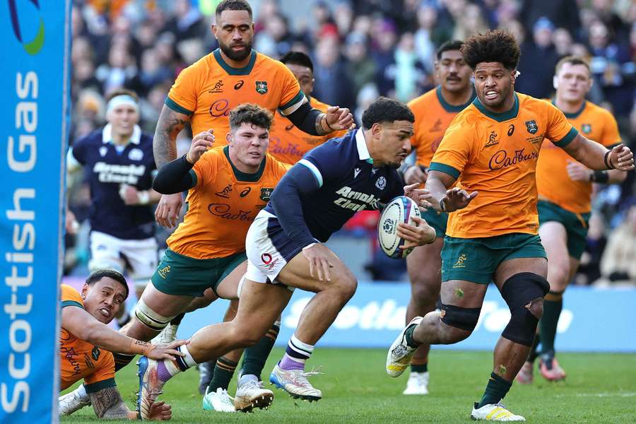 Scotland's captain Sione Tuipulotu (L) runs to the line to score the first try of a one-off Test against Australia at Murrayfield