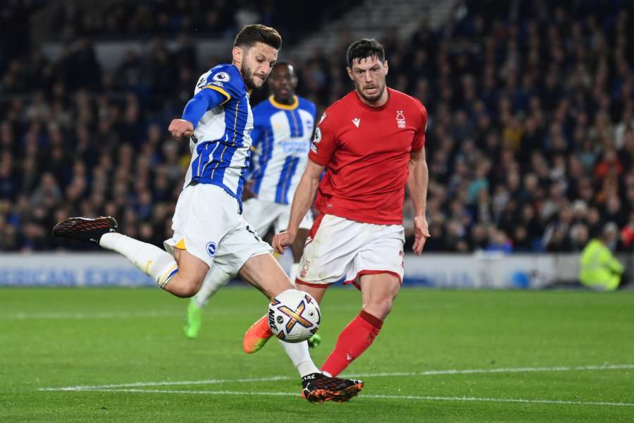 Adam Lallana controls the ball in front of Nottingham Forest's Scottish defender Scott McKenna