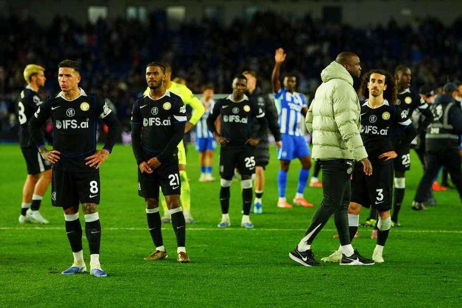 Chelsea players stand and stare at fans at full-time after the loss against Brighton