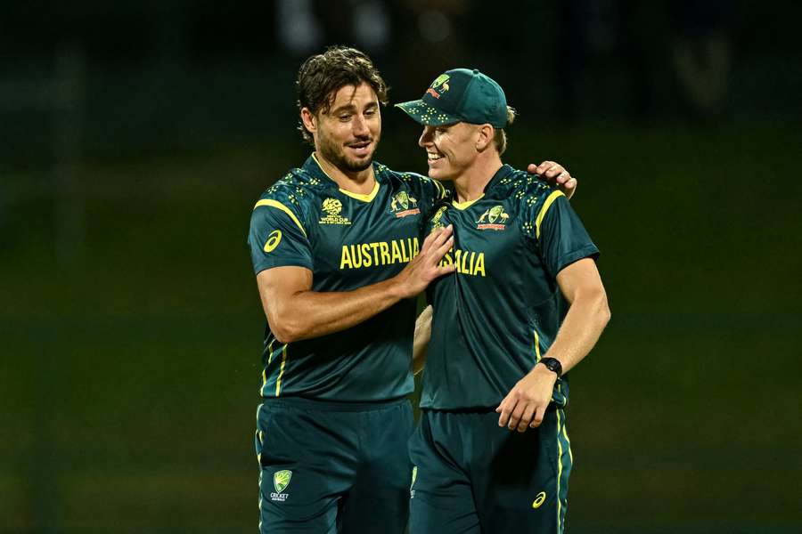 Marcus Stoinis and Nathan Ellis celebrate a wicket during Australia's consolation win over Oman. 