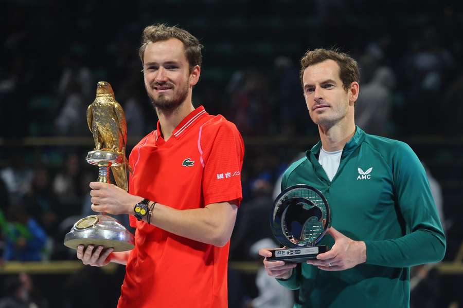 Russia's Daniil Medvedev and Britain's Andy Murray pose on the podium with their trophies after the Qatar Open final tennis match in Doha